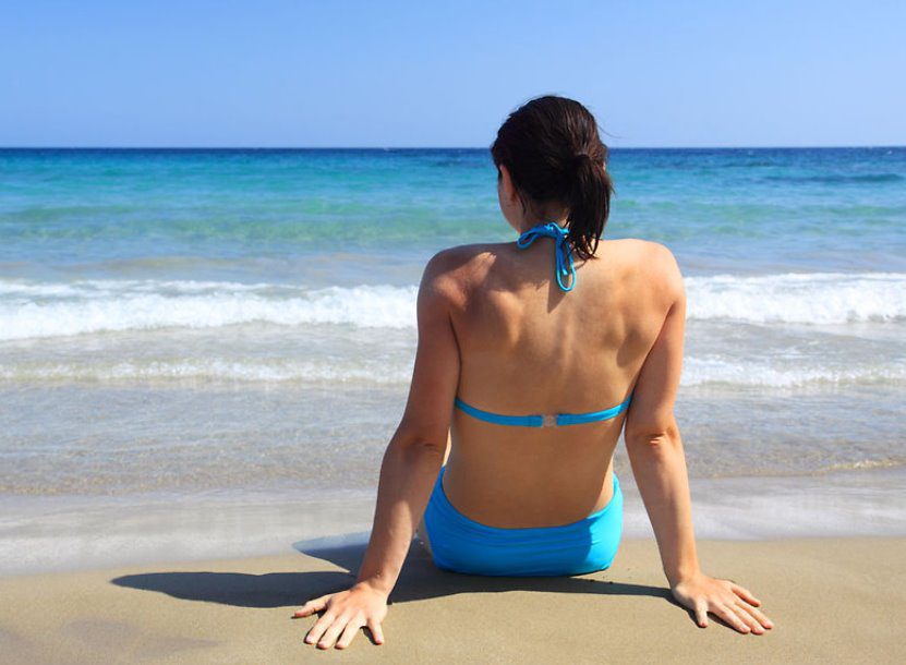 Woman sitting on the beach